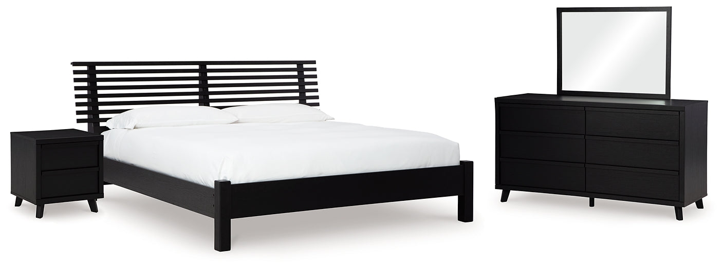 Danziar King Panel Bed with Mirrored Dresser and Nightstand